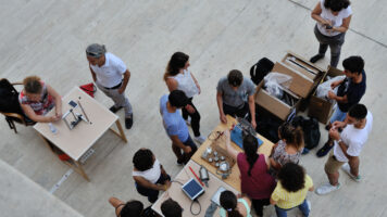 Foto dall'alto di studenti e studentesse che fanno esperimenti durante Lab2Go